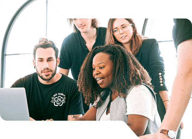 Group of diverse professionals collaborating around a laptop